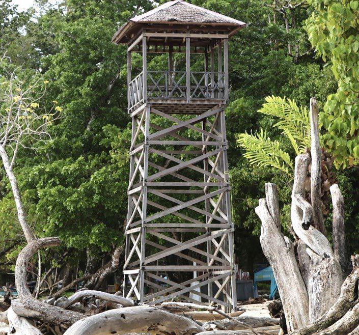 An old wooden watchtower beside the sea
