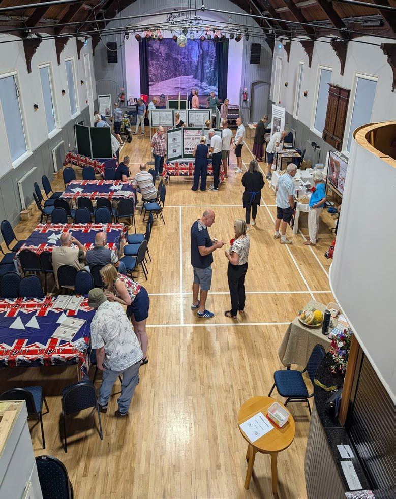 A village hall laid out with exhibition boards and tables