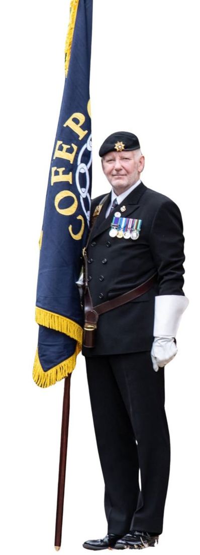 The COFEPOW standard bearer in beret and medals