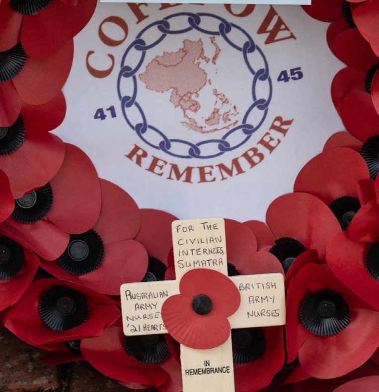 A poppy wreath bearing the COFEPOW emblem, with remembrance crosses